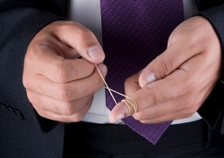 A man tightens an elastic band around his finger