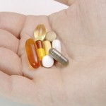Hand full of pills and vitamins