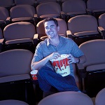 Man Watching Movie in Empty Theater