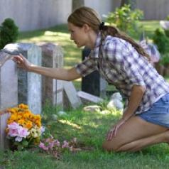woman-kneeled-over-headstone