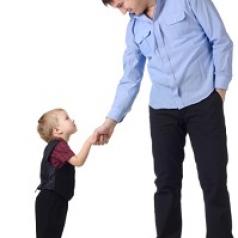 Blonde toddler boy shaking hands with dark-haired middle-aged man