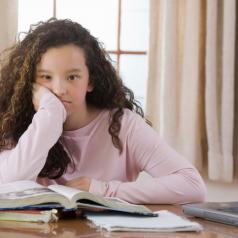 Young girl contemplates homework