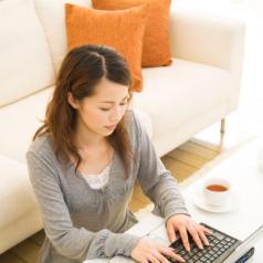 Woman using her laptop in living room