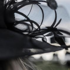 Cropped view of woman wearing fancy black hat with veil