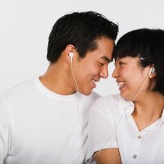 Asian couple listening to mp3 player