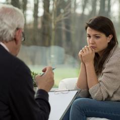 Young woman listens to therapist