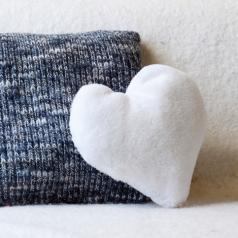 fuzzy heart pillow on couch