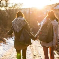 Girlfriends holding hands on a walk