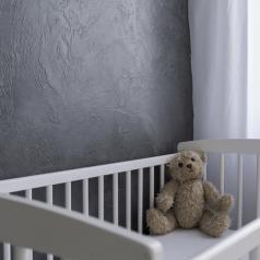 teddy bear in gloomy crib