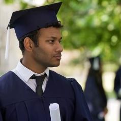 Graduate with worried face, holding diploma