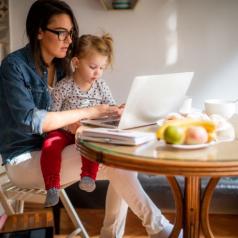 Mother with daughter working from home