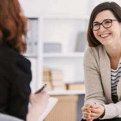 Woman patient smiling while practicing growth oriented psychotherapy