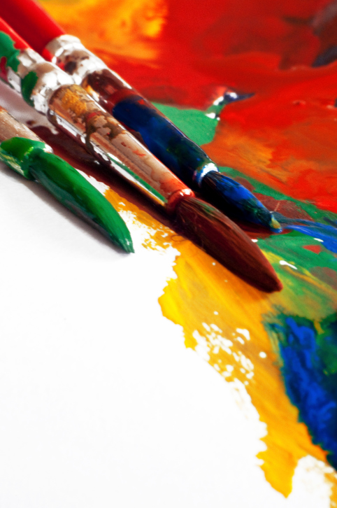 Paintbrushes and colorful splashes of paint