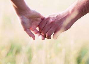 Two people holding hands