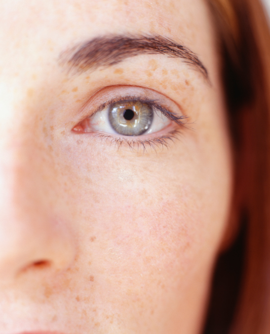 Close-up of red-haired person looking out