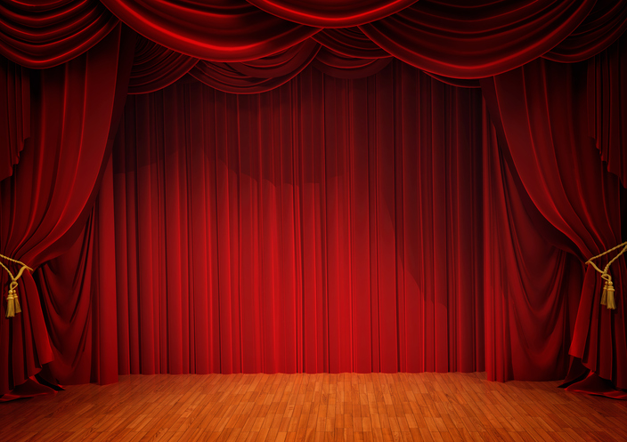 Red curtains open on a wood-floor stage