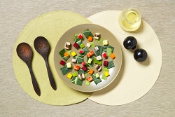 Very sparse salad artfully placed with place setting