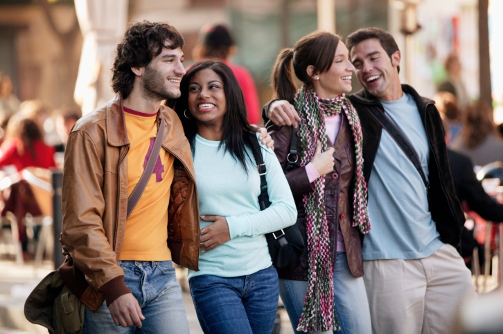 Two young adult couples walking in public