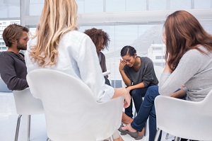 Woman cries in group therapy session