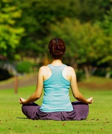 Woman meditates outside