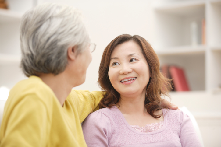 A woman smiles at her husband seated next to her