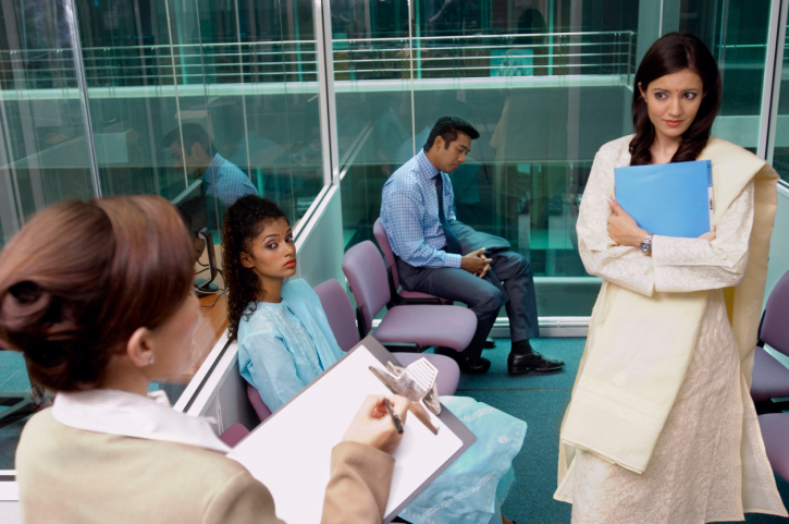 A young woman nervously awaits an interview