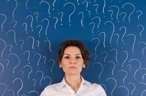 Woman surrounded by question marks