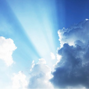 A ray of light shines through dark clouds.