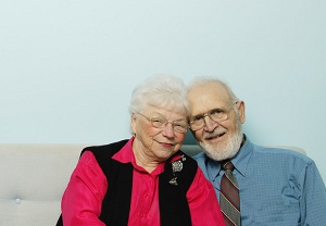 Elderly couple sitting on couch