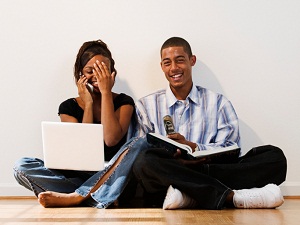 Happy couple with laptop and book