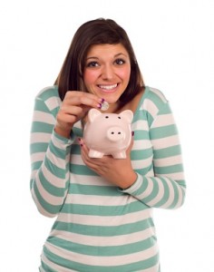 Woman puts coin in piggy bank