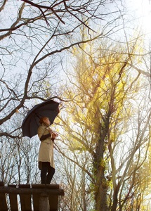A woman holds an umbrella. 
