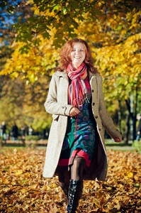 A woman walks through a park. 