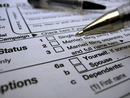 A pen hovers over the marital status section of a tax form.