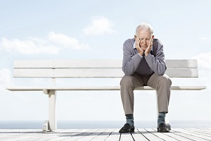 Sad man sitting alone on bench