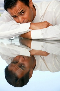 Man leaning on his arms on a table