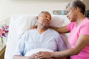 Patient in hospital bed with wife