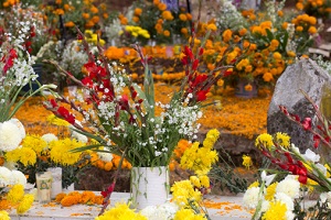 An alter is covered with flowers and candles.