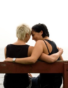 Woman with her arms around her husband painting together