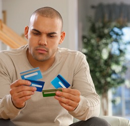 Man holds multiple credit cards