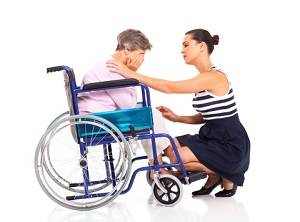 Woman comforting another woman in a wheelchair