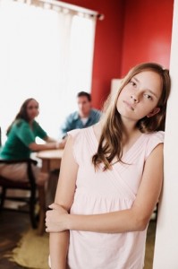 Girl leaning on wall looking sad