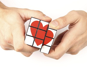 Hands solving rubik's cube with heart