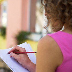 View over the shoulder of a woman making notes