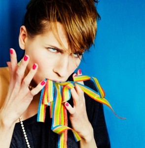 Woman with rainbow ribbons coming out of her mouth