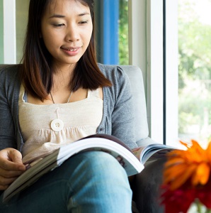 woman reading by window