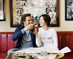 A couple toasts at a pub. 