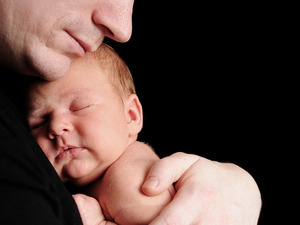 Father holding newborn