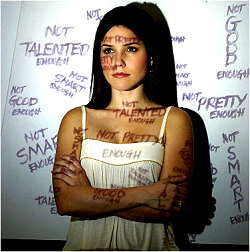 Woman with hurtful words projected on her