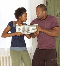 Couple fighting over oversized money